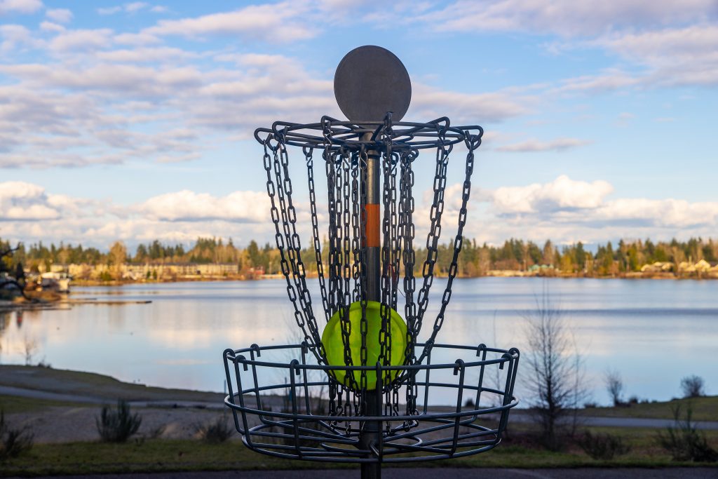 disc golf basket on pretty park course near a lake 2022 06 14 02 04 23 utc
